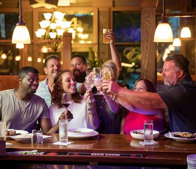 group of friends toasting at Emily's Bar and Restaurant